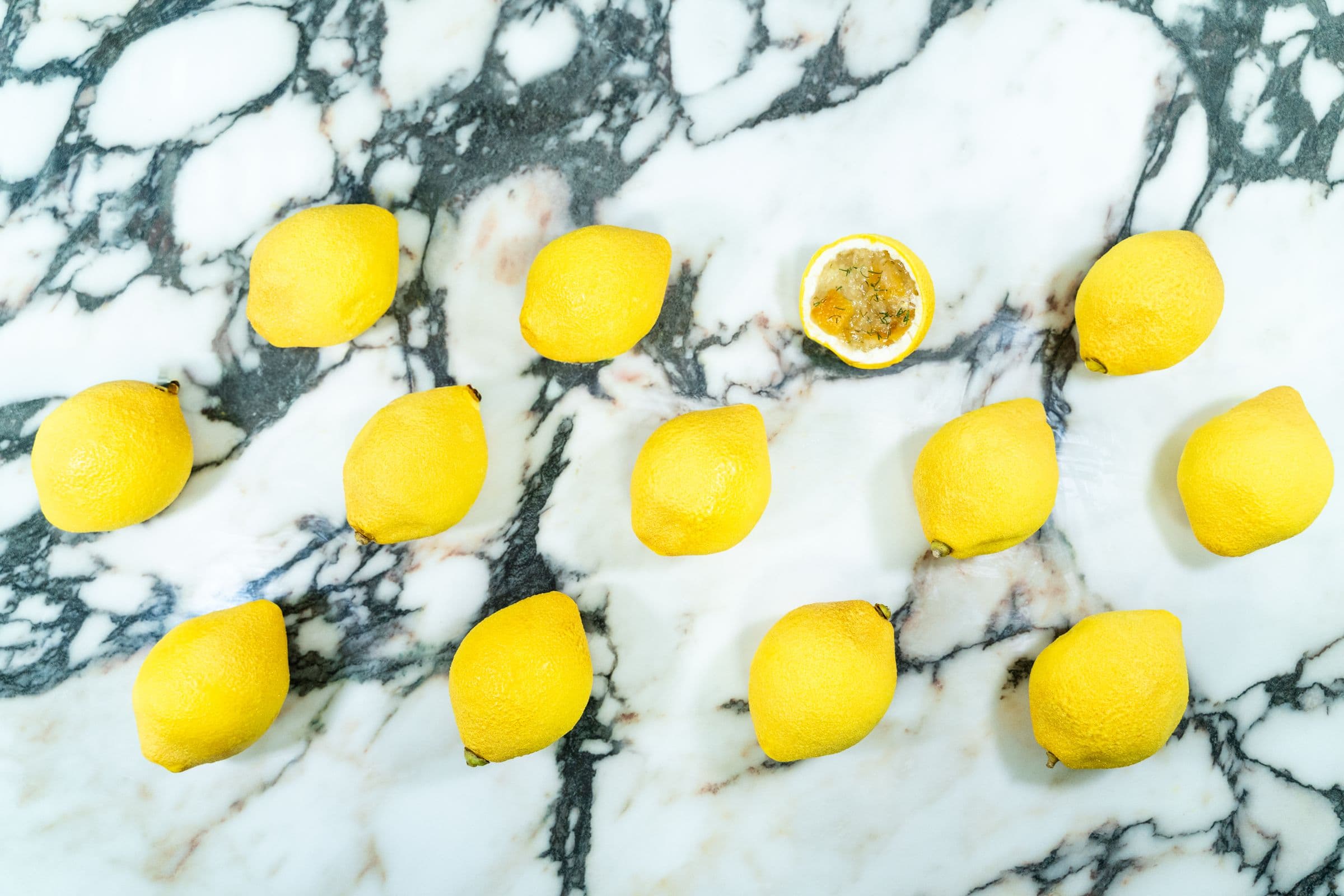 Lemon pastries, whole, arranged on white marble