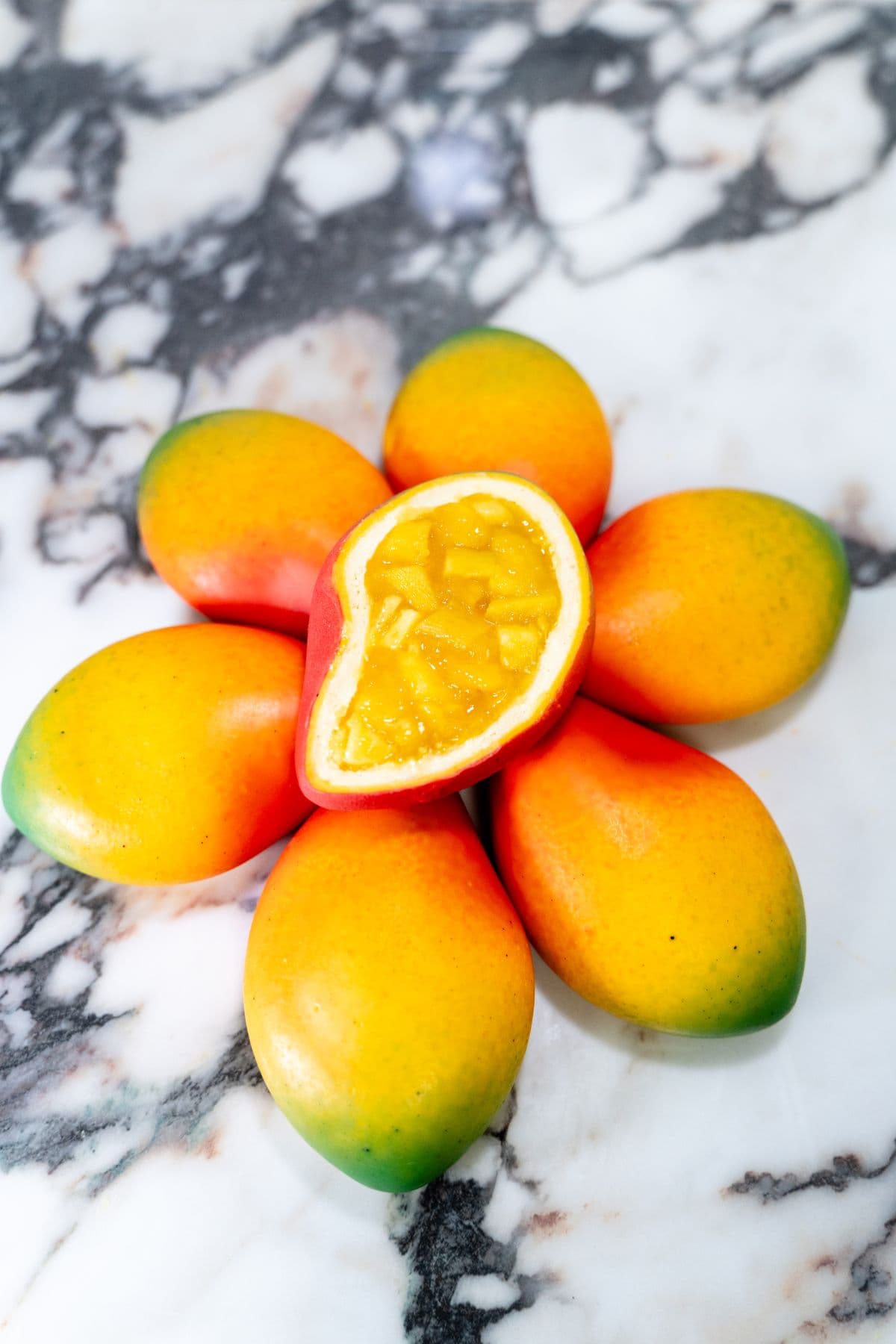 A mango pastry cracked open at the moment of serving