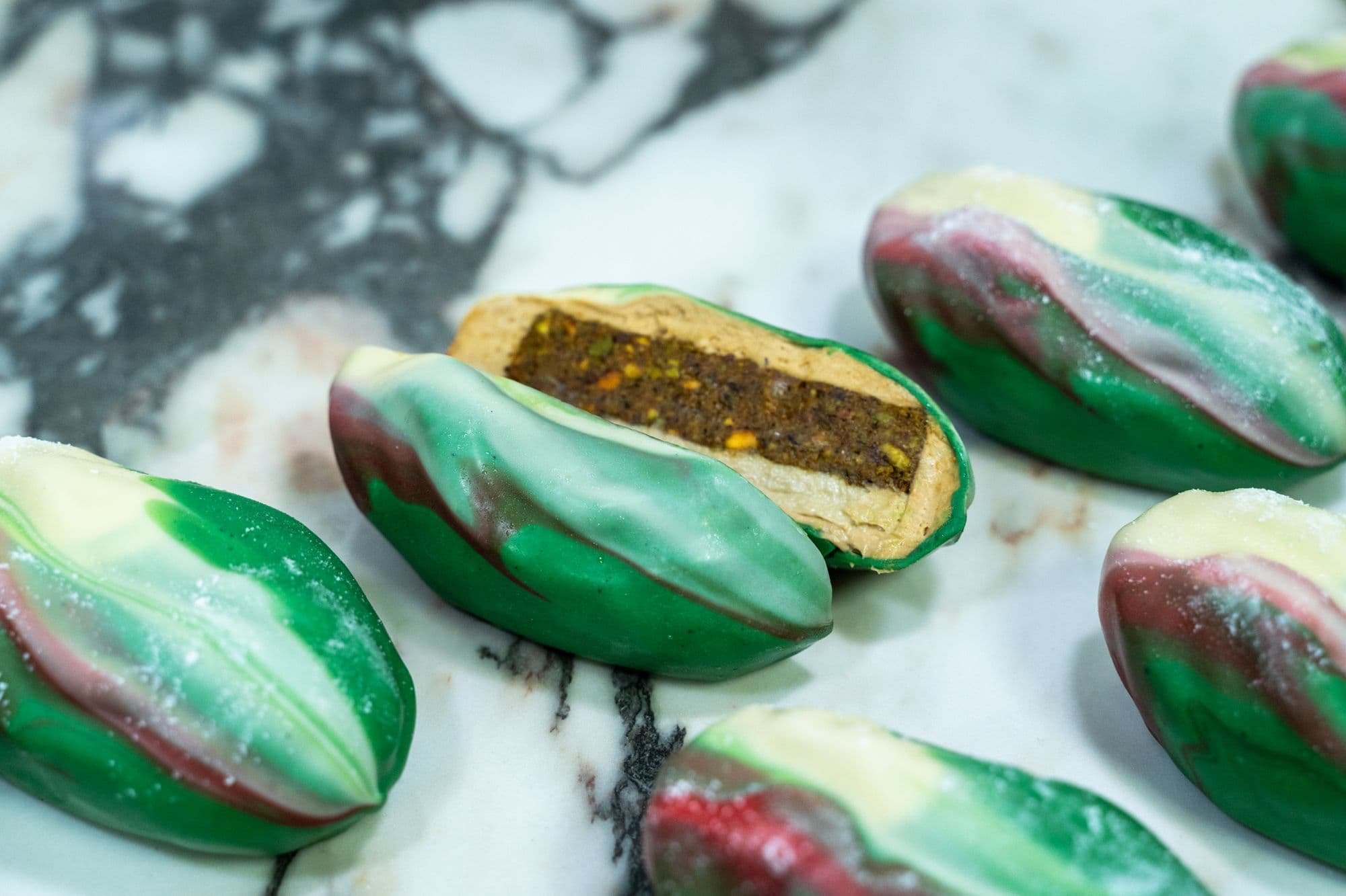 A pistachio pastry cut open, close up